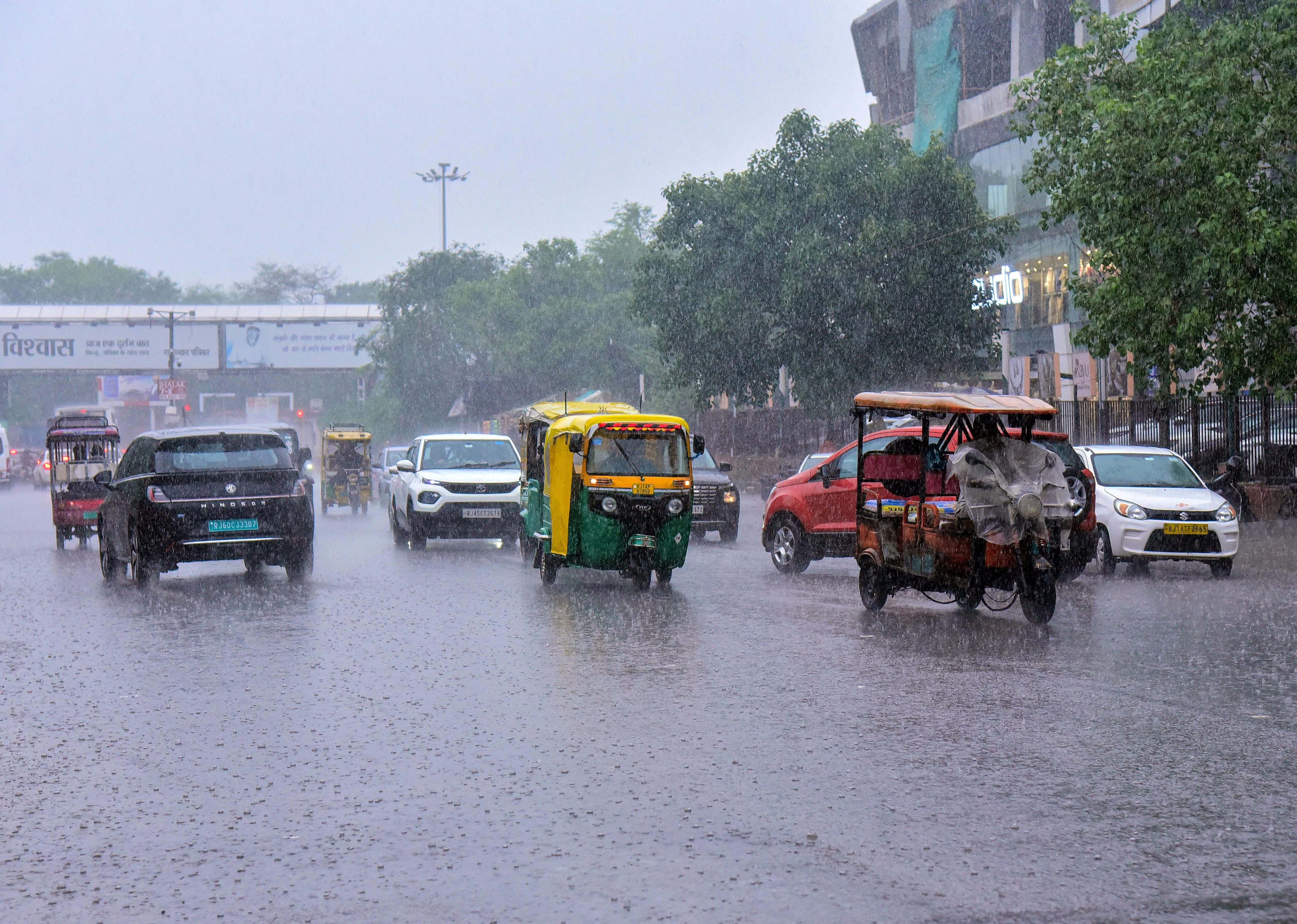 Jaipur: Commuters wade through waterlogged road after rainfall