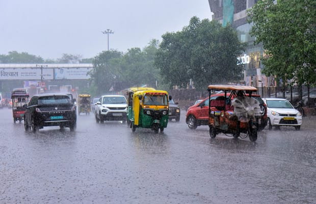 Jaipur: Commuters wade through waterlogged road after rainfall