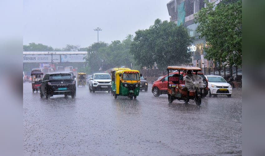 Jaipur: Commuters wade through waterlogged road after rainfall