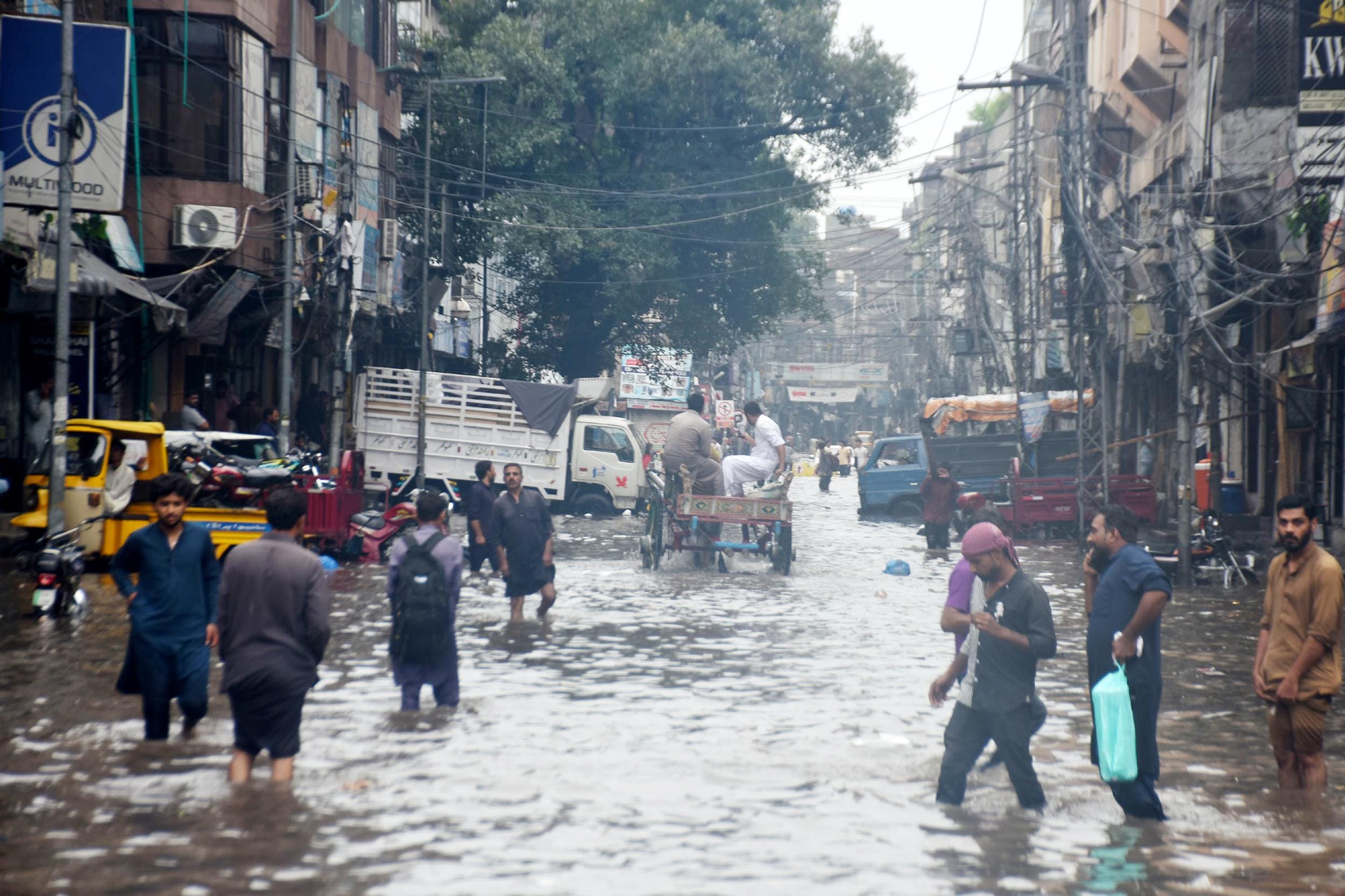 Lahore: Commuters make way through flooded roads after rain