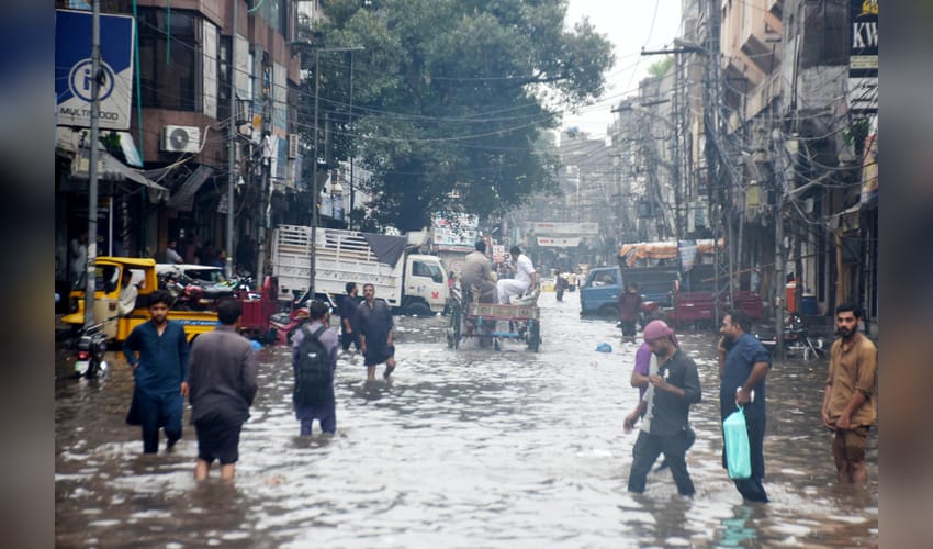 Lahore: Commuters make way through flooded roads after rain