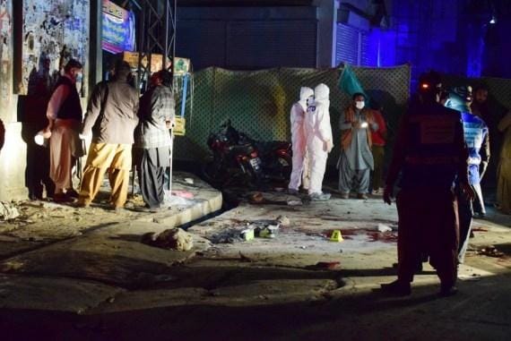 Security officers examine the blast site in Quetta, southwestern Pakistan, on Dec. 30, 2021,