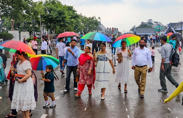 Shimla: Visitors walk with umbrellas amid rain