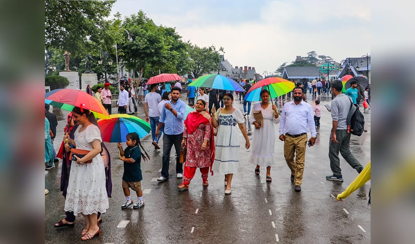 Shimla: Visitors walk with umbrellas amid rain